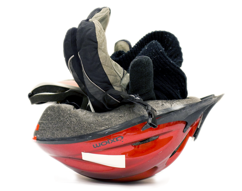 Ski goggles, balaclava and lobster mitts stuck into a helmet